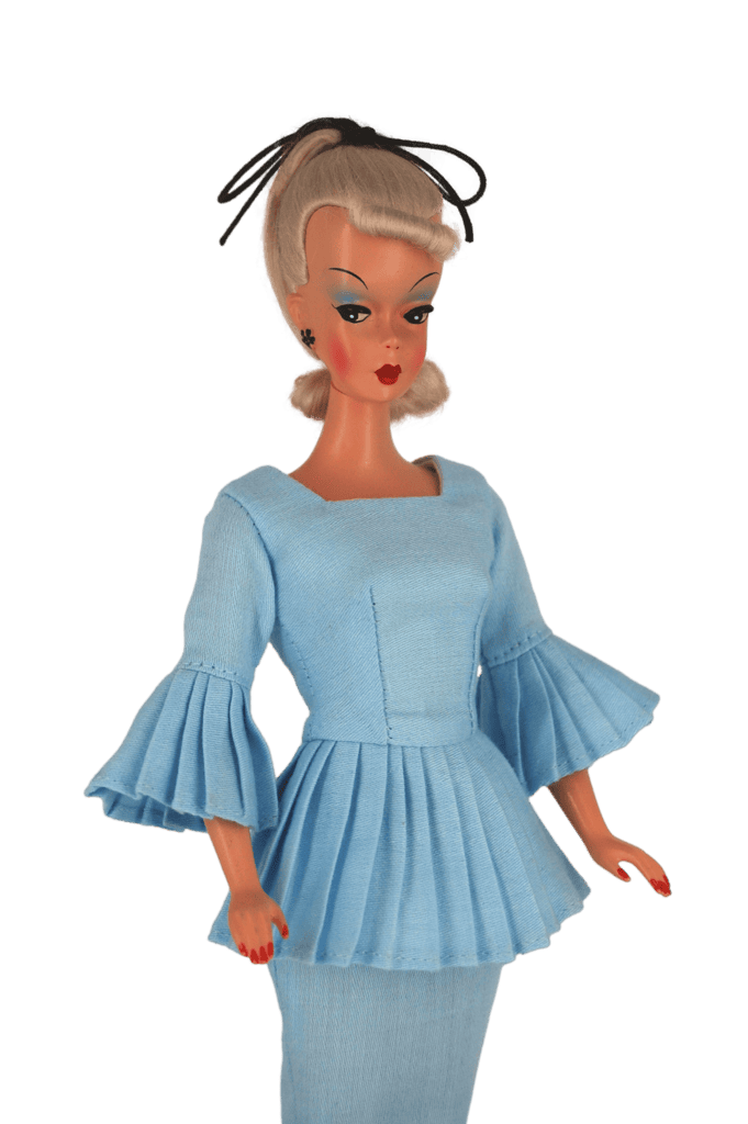 Bild Lilli doll in a powder blue peplum dress with pleated bell sleeves, reflecting classic vintage tailoring and elegance.