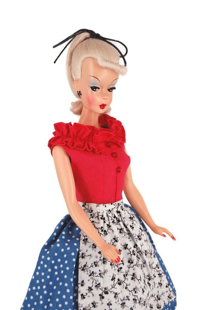 Bild Lilli doll in a red ruffled blouse with a blue polka-dot and floral skirt, blending vintage-inspired textures and bold 1950s style.