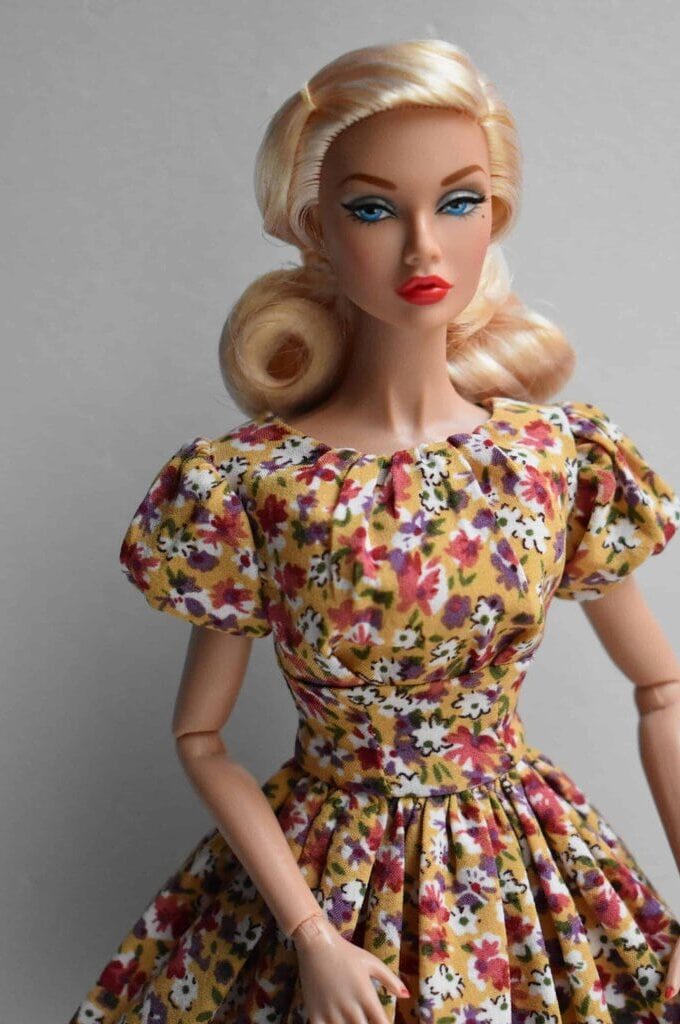 Mustard yellow floral doll dress with puffed sleeves, fitted bodice, and a full pleated skirt. Retro-inspired handmade fashion with autumnal charm.