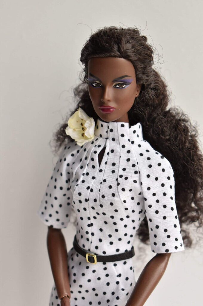 White polka dot pencil doll dress with a high neckline, tailored fit, and elbow-length sleeves. Vintage-inspired handmade fashion with classic elegance.