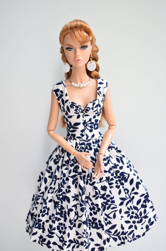 Classic fit-and-flare dress with navy blue floral pattern, ruched sweetheart bodice, and wide straps for effortless sophistication.