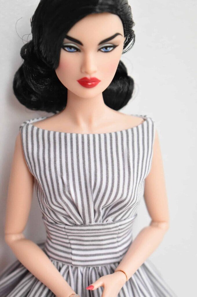 Timeless striped doll dress with a structured bodice, flattering cinched waist, and a full skirt, capturing effortless sophistication and retro charm in a tailored fit.