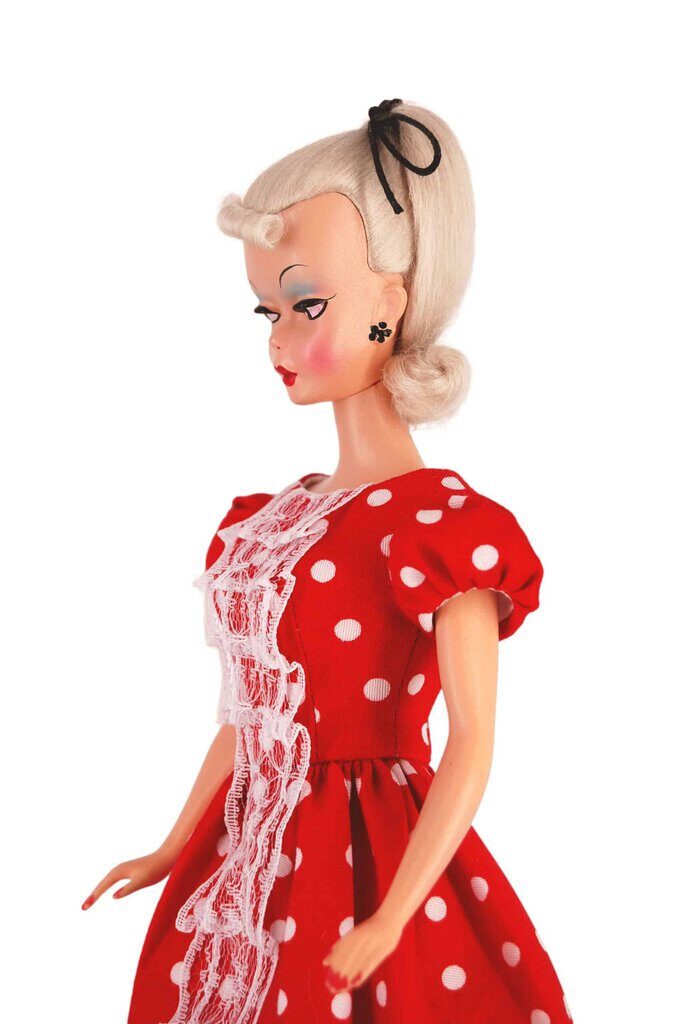 Bild Lilli doll in a red polka-dot dress with puff sleeves and lace trim, reflecting 1950s charm and vintage-inspired style.